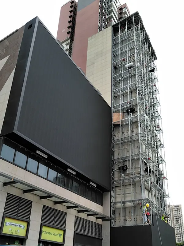 Adhaiwell industrial-grade aluminum LED display installation on a high-rise building facade with professional steel structure and engineering team.