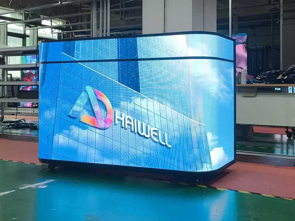 `Adhaiwell front ellipse counter curved LED display from China factory supplier, mobile all‑in‑one digital screen for playing corporate promotional videos at lobby and reception counters`