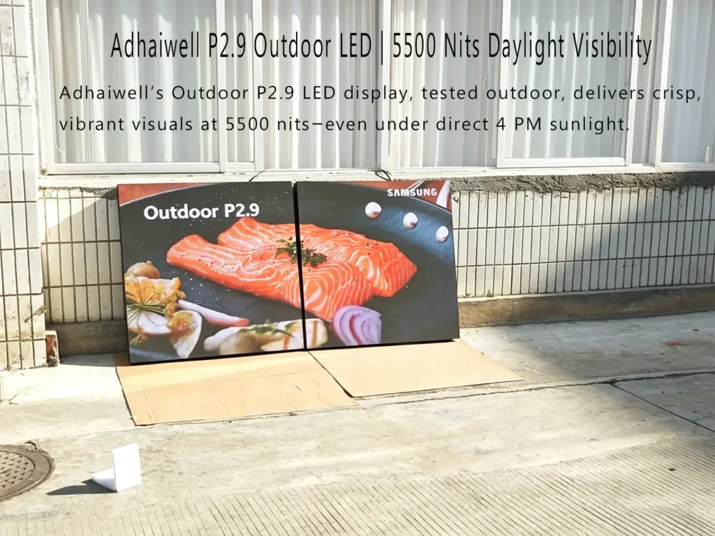 Adhaiwell Outdoor P2.9 LED display with 5500 nits brightness, showing clear salmon image under direct afternoon sunlight